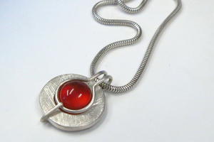 Silver and carnelian pendant featuring my "fold over" setting.