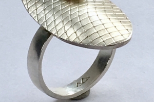 Silver ring with textured panel and white freshwater pearl